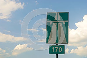 Sign of the highway against the sky
