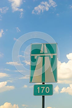 Sign of the highway against the sky