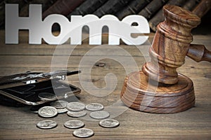 Sign Home, Gavel, Purse And Old Book On Wood Table