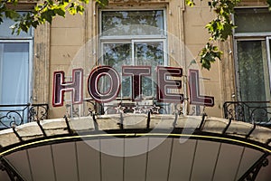 Sign Hotel at an old facade in red letters in Aix en Provence
