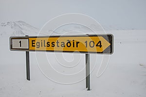 Sign in the Icelandic highlands telling there are 104 kilometers to the nearest town Egilsstadir