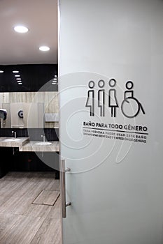 Sign of inclusive bathrooms for all genders in Spanish combating discrimination trans women and men, people with disabilities