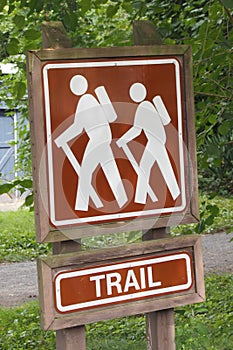 The sign indicates that there is a hiking trail ahead. Follow the path that other hikers have taken.