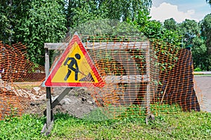Sign indicating road works and excavations in summer
