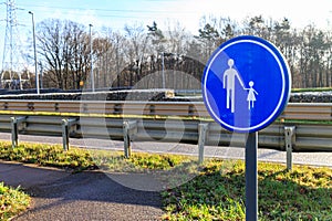 Sign indicating: Walking area or pedestrian route next to country road