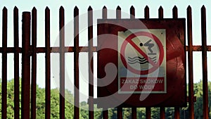 The sign informing about the prohibition of swimming photo