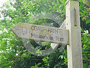 Sign with the inscription Coastal Path to Mousehole Cornwall England photo