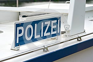 Sign with the inscription police on a police boat in Germany