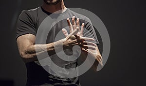 Sign language man interpreter gestures over stage during public event