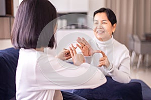 Sign language specialist talking with senior patient deaf hearing and showing hands gesture