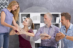 Sign language teacher correcting her students