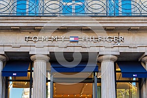 Sign and logo at the entrance to the Parisian flagship store of Tommy Hilfiger, Paris, France