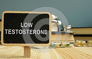 Sign low testosterone and book on wooden surface