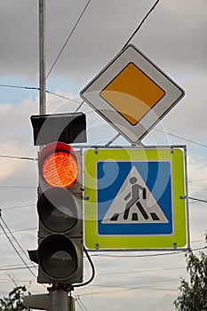 Sign main road. pedestrian crossing sign. red traffic signal