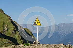 Sign man falling from a height, danger of falling from a cliff, mountain collapses, warning of an abyss