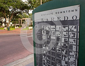 Sign with map of the historic downtown Laredo, Texas, USA, with a park in the background photo