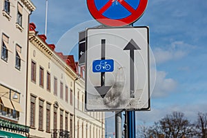 Sign marking a one way road. Bikes are allowed to travel the oposite way..