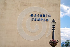 Sign for a masonic temple with a lightpost