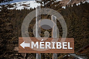 Sign for Meribel, a village in french alps, white letters on bro