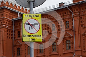 Sign No Fly Zone in English and Russian, the silhouette of the drone crossed out by a prohibition strip. Sign prohibiting flying