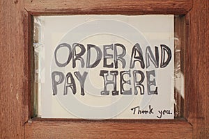 Sign order and pay here sign used in restaurants and coffee cafe