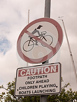 Sign outside caution no biking red circle crossed footpath only