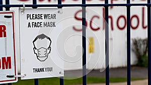 Sign outside a school requesting face masks be worn