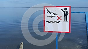Sign over water to not feed the birds. Do not feed the animals wildlife birds sign with copy space on water background