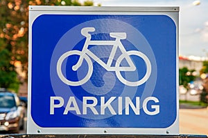 Sign Parking for bicycles on the street. White silhouette of a bicycle on a blue background