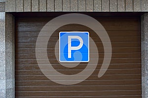 Sign `Parking`. Parking a car.