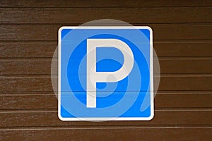 Sign `Parking`. Parking a car.