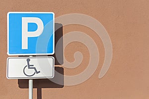 Sign of people with a mobility impairment on parking place.