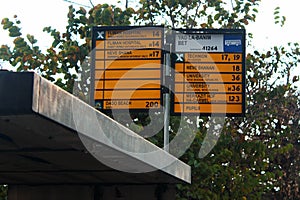 Sign plate with names of local bus stops and city bus routes in Haifa, Israel