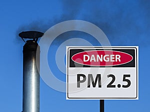 Sign of pm 2.5 and the house chimney with smoke in the sky.