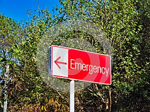 Sign Pointing Direction to Hospital Emergency Entrance