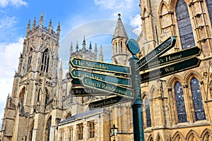 Sign post with landmarks of the city of York, England with York Minster in the background
