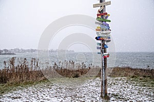 Sign Post with Locations in a Winter Storm