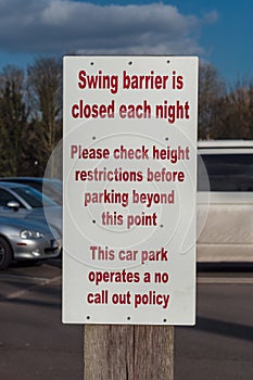 Sign post for swing barrier in a car park