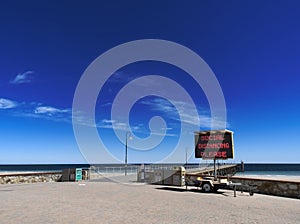 Sign and poster for COVID-19 at the Glenelg Jetty