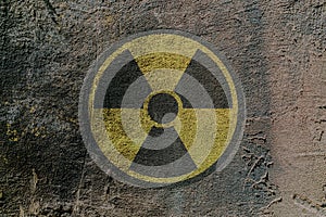 Sign of radioactive danger depicted on a concrete wall