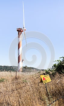 A sign reading `Danger Mines!` hangs from a barbed wire fence in the Golan Heights, near the border with Syria, Israel