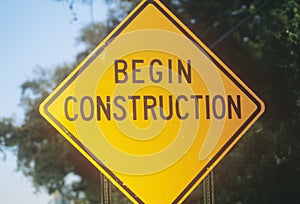A sign that reads Ã¯Â¿Â½Begin ConstructionÃ¯Â¿Â½