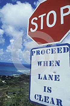 A sign that reads ï¿½Stop - proceed when lane is clearï¿½