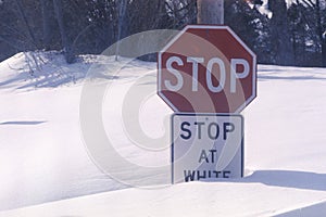 A sign that reads ï¿½Stop, stop at white lineï¿½