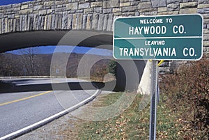 A sign that reads ï¿½Welcome to Haywood Co.; Leaving Transylvania Co.ï¿½