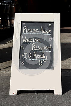 Sign requiring proof of full vaccination plus ID in order to dine inside