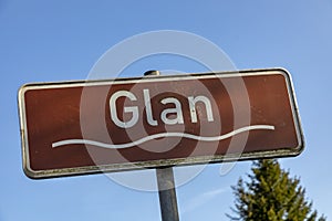 Sign river Glan under blue sky with wave symbol and brown color