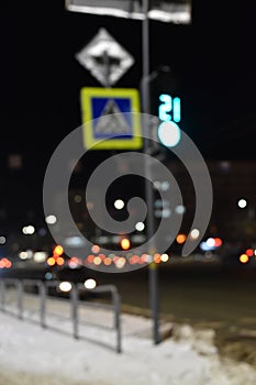 The sign of the road crossing and the lights of the night city