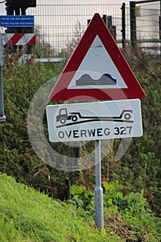 Sign on a road in the Netherlands to warn for coming steep railroad crossing