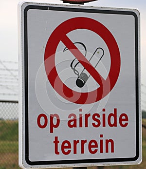 Sign on Rotterdam The Hague Airport that smoking is not allowed on the airside area. photo